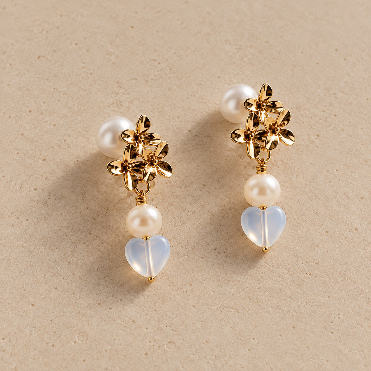The Fiona gold floral pearl and opalite heart drop earrings by Nacre & Atlas