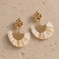 The Palma ivory raffia fan and gold floral statement earrings by Nacre & Atlas